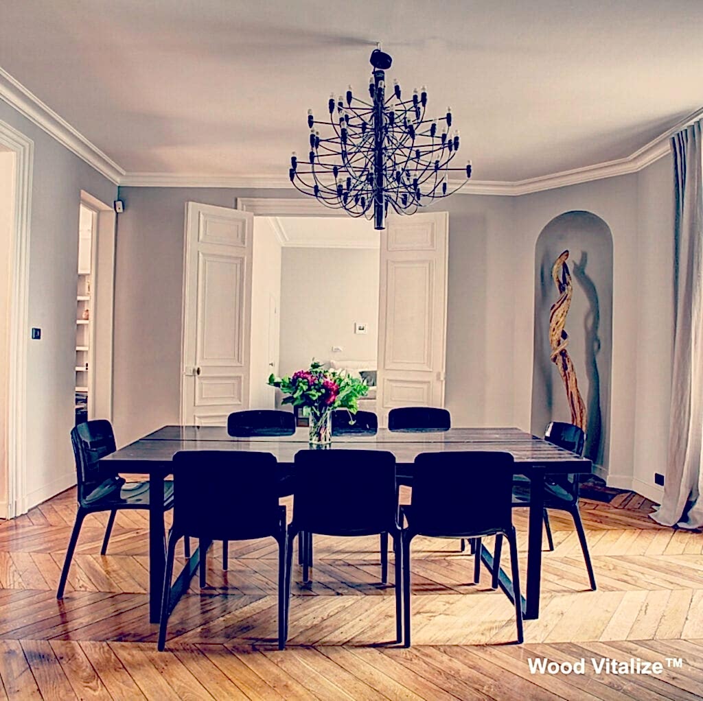 Black dining chairs surrounding glossy wooden table