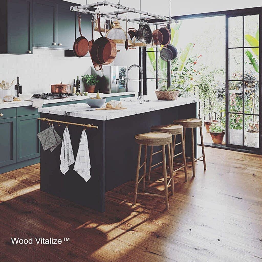 Modern kitchen with island and hanging pots.