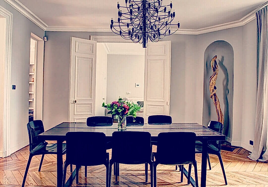 Modern chandelier over restored wood floors Modern chandelier over restored wood floors